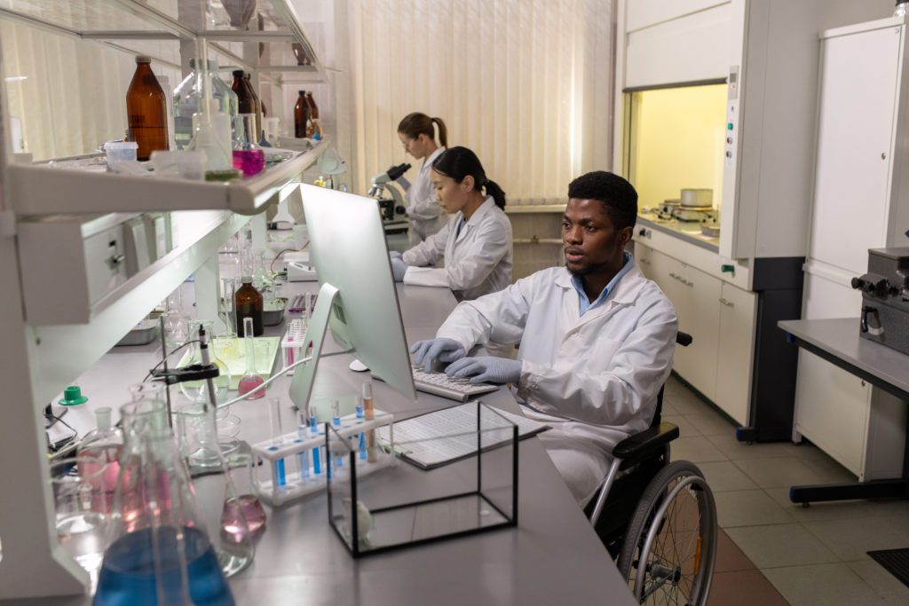 A Disabled Scientist Sitting in a Wheelchair Working in the Lab